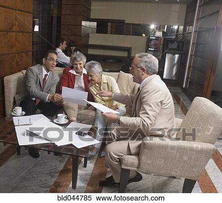 Stock Photography - Hispanic businesspeople having meeting. Fotosearch