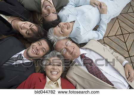 Hispanic businesspeople laying on floor View Large Photo Image Stock Image - Hispanic businesspeople laying on floor. Fotosearch