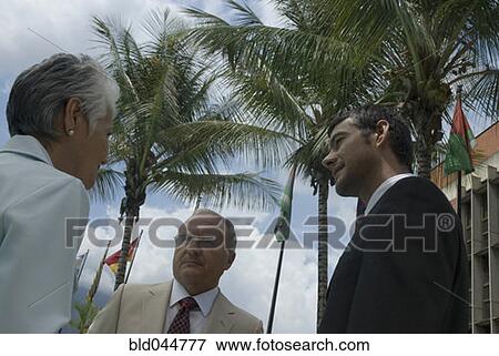 Hispanic businesspeople talking outdoors View Large Photo Image Stock Photo - Hispanic businesspeople talking outdoors. Fotosearch