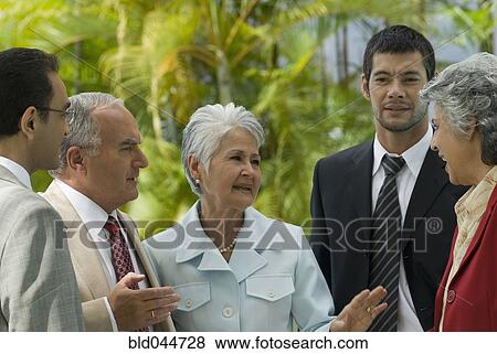 Stock Photo - Hispanic businesspeople talking. Fotosearch