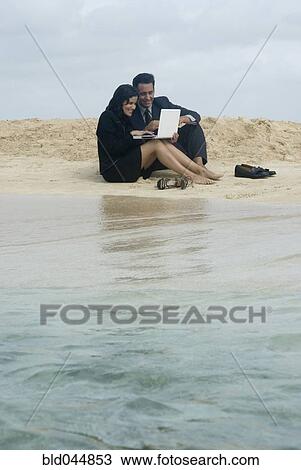 Hispanic businesspeople working at beach View Large Photo Image Stock Image - Hispanic businesspeople working at beach. Fotosearch