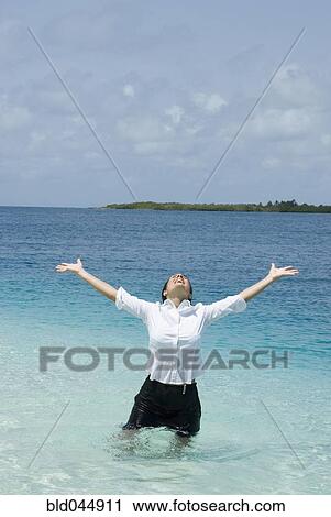 Hispanic businesswoman in water with arms raised View Large Photo Image Stock Image - Hispanic businesswoman in water with arms raised. Fotosearch