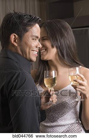 Stock Photograph - Hispanic couple drinking wine. Fotosearch