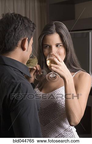 Stock Photography - Hispanic couple drinking wine. Fotosearch