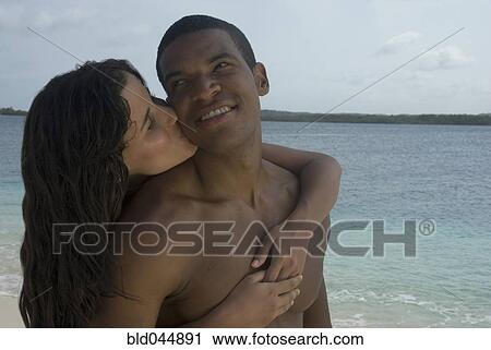 Hispanic couple hugging at beach View Large Photo Image Stock Image - Hispanic couple hugging at beach. Fotosearch