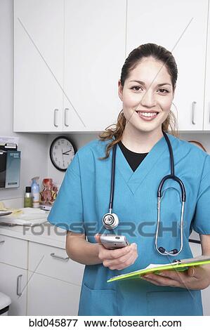 Stock Photo - Hispanic female medical professional holding chart. Fotosearch