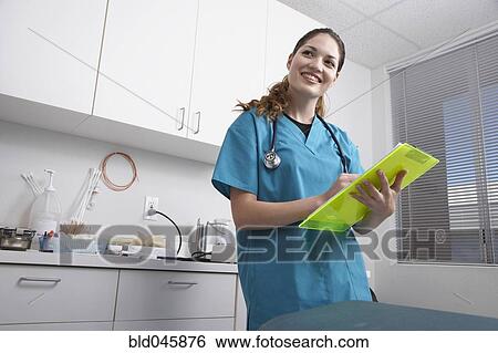 Hispanic female medical professional holding chart View Large Photo Image Stock Photograph - Hispanic female medical professional holding chart. Fotosearch