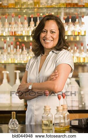 Stock Photo - Hispanic female sales clerk at perfume store. Fotosearch