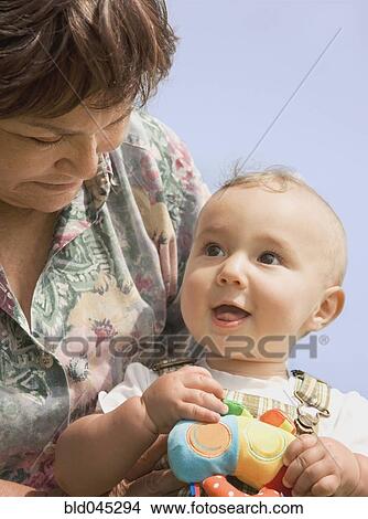 Hispanic grandmother holding baby View Large Photo Image Picture - Hispanic grandmother holding baby. Fotosearch