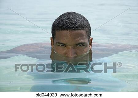 Stock Photo - Hispanic man in water. Fotosearch