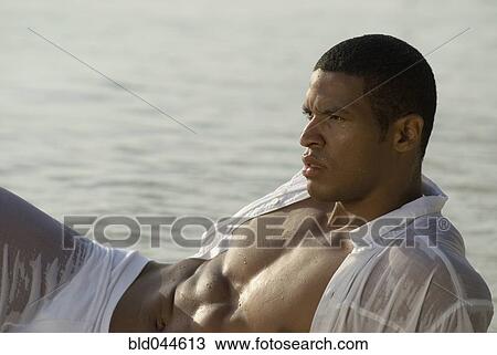 Hispanic man in wet clothing at beach View Large Photo Image Stock Image - Hispanic man in wet clothing at beach. Fotosearch