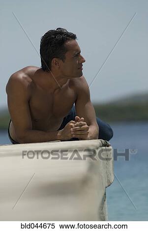 Hispanic man laying on dock View Large Photo Image Stock Photography - Hispanic man laying on dock. Fotosearch