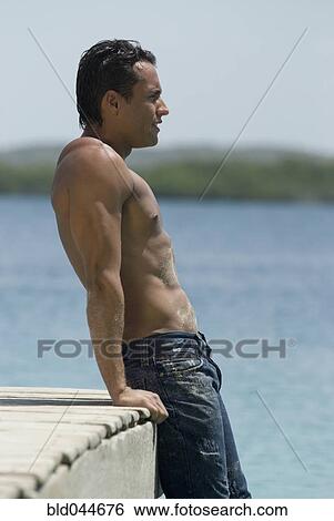Hispanic man leaning on dock View Large Photo Image Stock Photograph - Hispanic man leaning on dock. Fotosearch