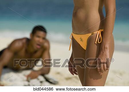 Hispanic man looking at woman on beach View Large Photo Image Stock Photograph - Hispanic man looking at woman on beach. Fotosearch