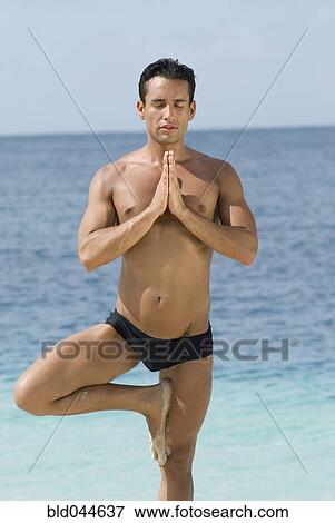 Hispanic man practicing yoga at beach View Large Photo Image Stock Photo - Hispanic man practicing yoga at beach. Fotosearch