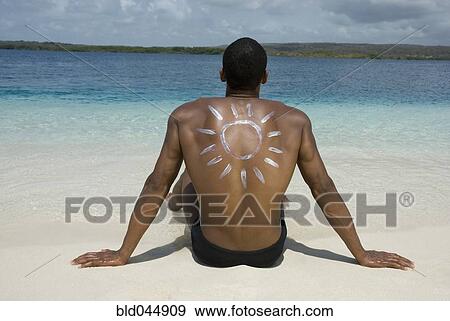Hispanic man sitting on beach View Large Photo Image Stock Photo - Hispanic man sitting on beach. Fotosearch
