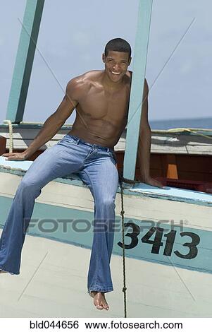 Hispanic man sitting on boat View Large Photo Image Stock Photograph - Hispanic man sitting on boat. Fotosearch
