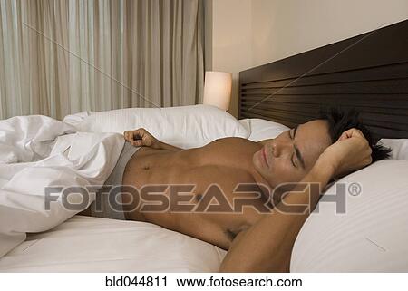 Hispanic man sleeping in bed View Large Photo Image Stock Image - Hispanic man sleeping in bed. Fotosearch