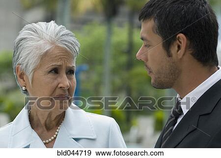 Hispanic mother and adult son talking View Large Photo Image Stock Photo - Hispanic mother and adult son talking. Fotosearch