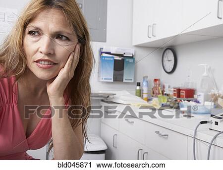 Stock Image - Hispanic woman at doctor’s office. Fotosearch
