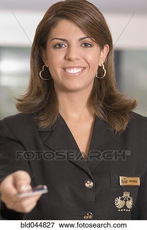 Stock Photo - Hispanic woman handing back credit card. Fotosearch