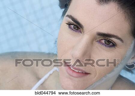 Picture - Hispanic woman in swimming pool. Fotosearch