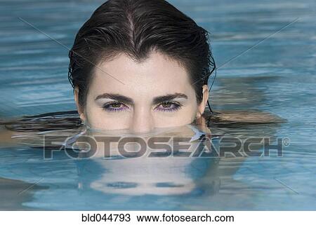 Stock Image - Hispanic woman in swimming pool. Fotosearch