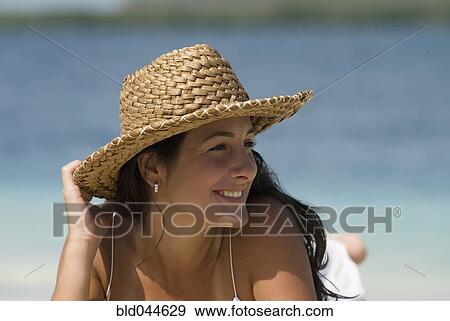 Hispanic woman wearing straw hat View Large Photo Image Stock Photo - Hispanic woman wearing straw hat. Fotosearch