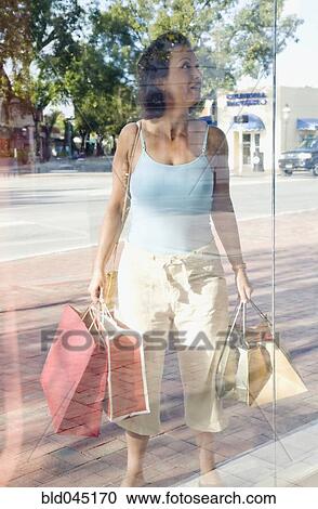 Hispanic woman window shopping View Large Photo Image Stock Image - Hispanic woman window shopping. Fotosearch