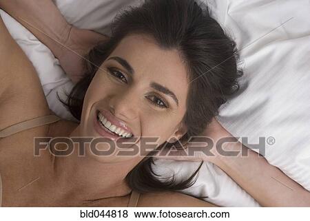 Hispanic woman with hands behind head View Large Photo Image Stock Photo - Hispanic woman with hands behind head. Fotosearch