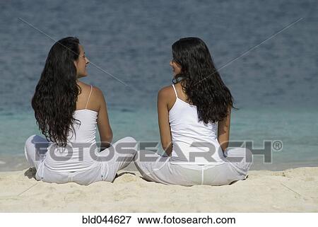 Hispanic women sitting on beach View Large Photo Image Stock Photo - Hispanic women sitting on beach. Fotosearch