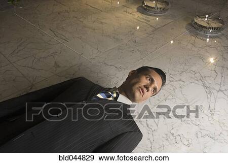 Stock Photo - Low angle view of Hispanic businessman. Fotosearch
