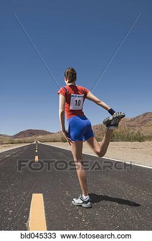 Mixed Race female runner stretching View Large Photo Image Stock Image - Mixed Race female runner stretching. Fotosearch
