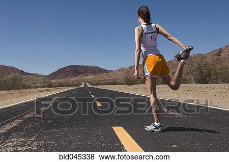 Mixed Race female runner stretching View Large Photo Image Stock Photo - Mixed Race female runner stretching. Fotosearch