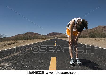 Stock Photograph - Mixed Race female runner stretching. Fotosearch