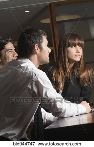 Stock Photo - Multi-ethnic businesspeople at meeting. Fotosearch