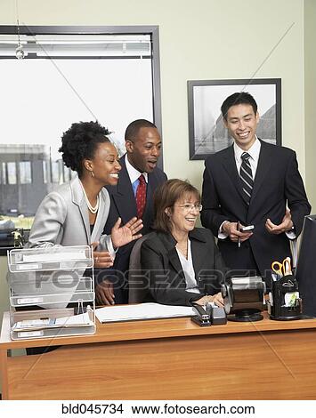 Picture - Multi-ethnic businesspeople cheering. Fotosearch