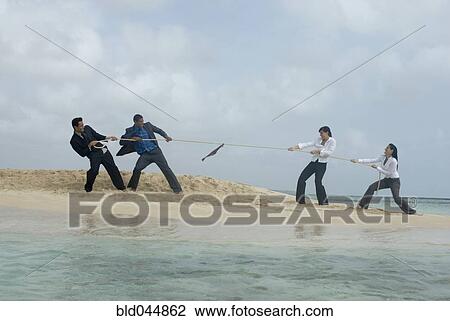 Multi-ethnic businesspeople having tug of war View Large Photo Image Stock Image - Multi-ethnic businesspeople having tug of war. Fotosearch