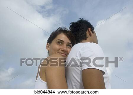 Multi-ethnic couple hugging View Large Photo Image Picture - Multi-ethnic couple hugging. Fotosearch