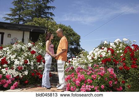 Stock Image - Multi-ethnic couple smiling at each other. Fotosearch