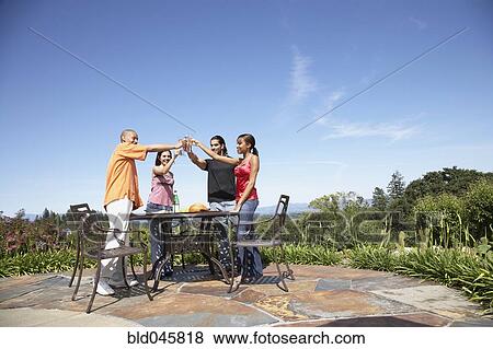 Multi-ethnic couples toasting outdoors View Large Photo Image Stock Photo - Multi-ethnic couples toasting outdoors. Fotosearch