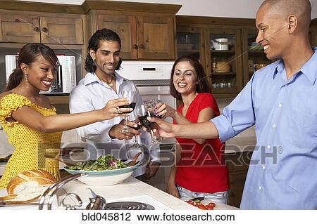 Stock Image - Multi-ethnic couples toasting with wine. Fotosearch