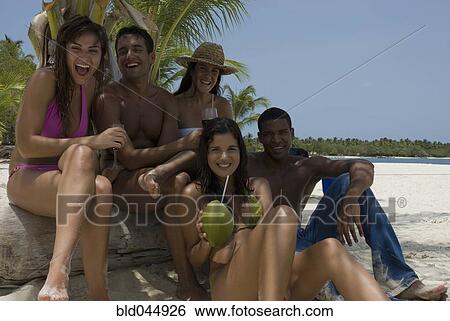 Stock Photograph - Multi-ethnic friends at beach. Fotosearch
