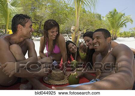 Stock Photography - Multi-ethnic friends at beach. Fotosearch