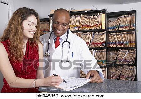 Multi-ethnic medical professionals discussing chart View Large Photo Image Stock Photo - Multi-ethnic medical professionals discussing chart. Fotosearch