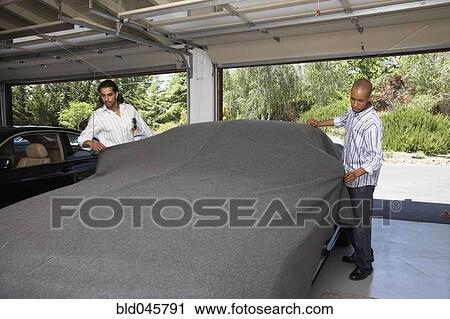 Stock Image - Multi-ethnic men covering car. Fotosearch