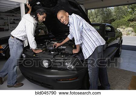 Multi-ethnic men looking under hood of car View Large Photo Image Stock Image - Multi-ethnic men looking under hood of car. Fotosearch