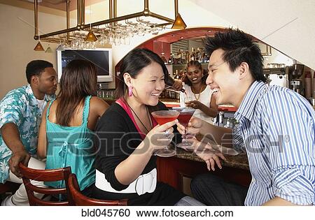 Multi-ethnic people sitting at bar View Large Photo Image Stock Image - Multi-ethnic people sitting at bar. Fotosearch
