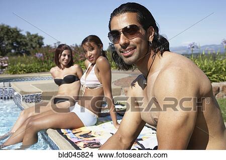Picture - Multi-ethnic women looking at Indian man. Fotosearch