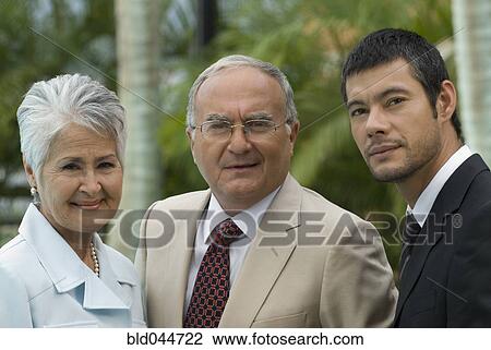 Stock Image - Portrait of Senior Hispanic parents and adult son. Fotosearch